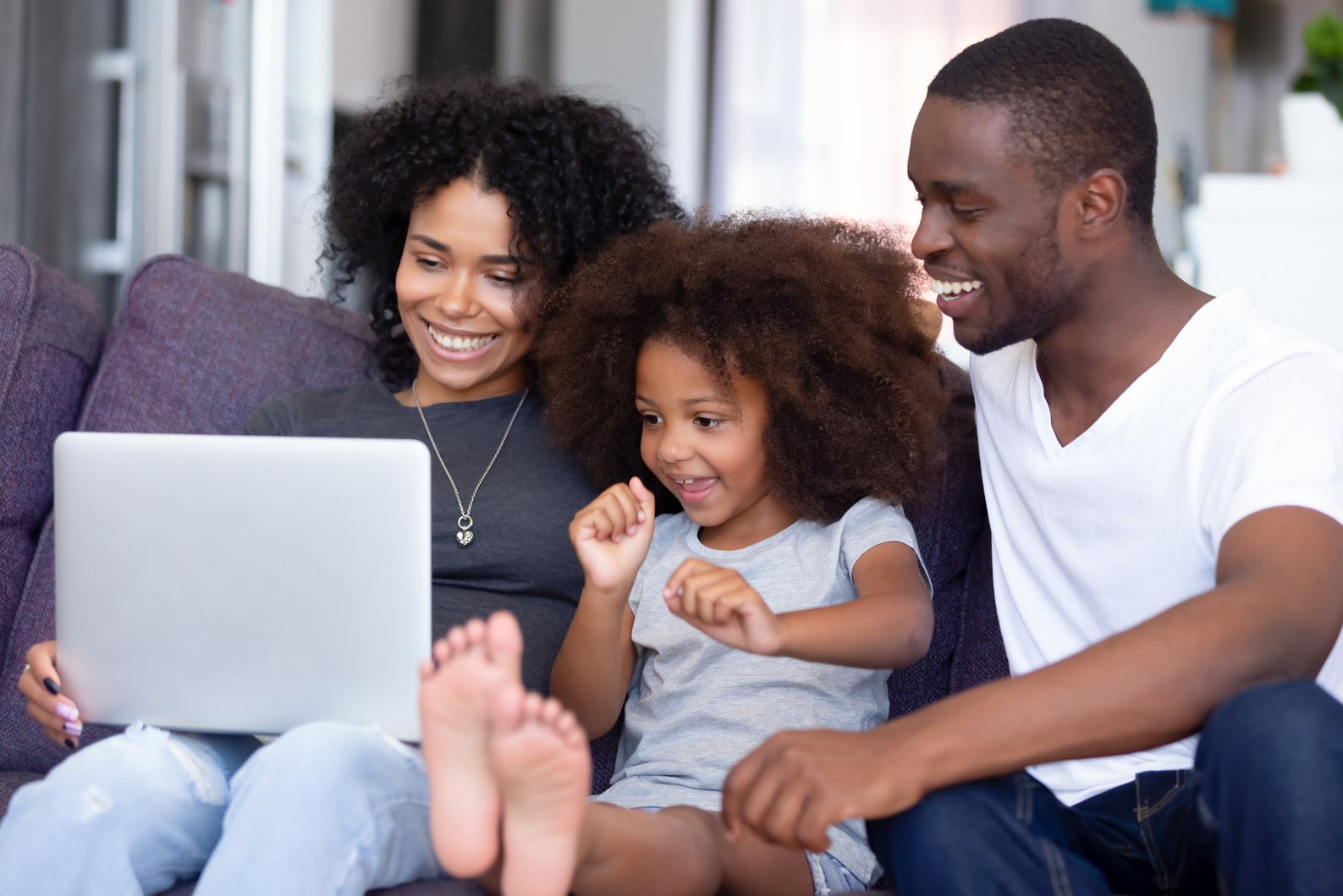 Happy family relax on couch watching movie online